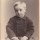 J.H. Kent CDV of little Victorian boy behind sofa